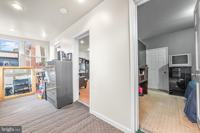 corridor featuring recessed lighting, carpet, and baseboards