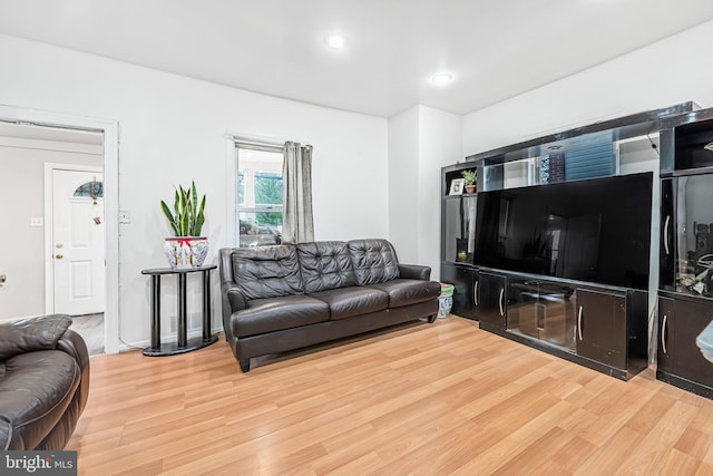 living room featuring light wood-style flooring and recessed lighting