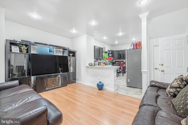 living room with recessed lighting and light wood-style floors