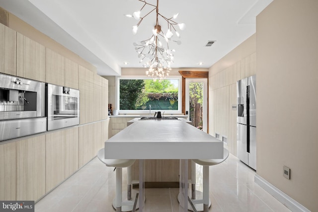 1227 S St NW, Washington, DC 20009 - kitchen with light tile patterned floors, an inviting chandelier, modern cabinets, stainless steel refrigerator with ice dispenser, and light countertops