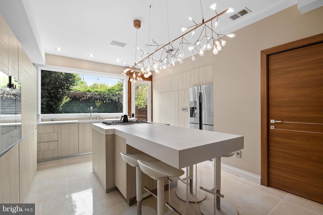 1227 S St NW, Washington, DC 20009 - kitchen with an inviting chandelier, modern cabinets, visible vents, a center island, and stainless steel appliances