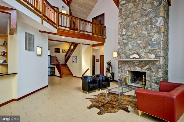 6525 76th St, Cabin John, MD 20818 - living area featuring baseboards, high vaulted ceiling, stairs, a stone fireplace, and wood finished floors