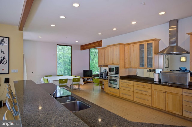 6525 76th St, Cabin John, MD 20818 - kitchen with stainless steel appliances, wall chimney range hood, recessed lighting, a sink, and glass insert cabinets