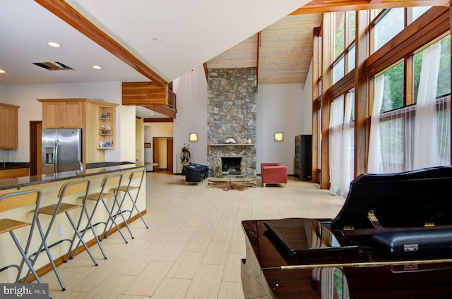 6525 76th St, Cabin John, MD 20818 - living area with a towering ceiling, a stone fireplace, and recessed lighting