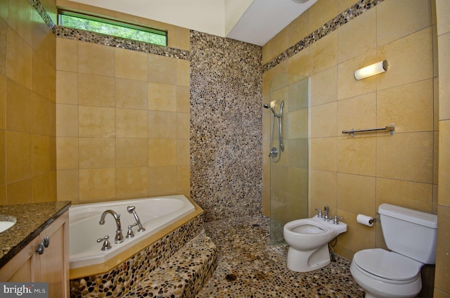 6525 76th St, Cabin John, MD 20818 - bathroom with tile walls, toilet, a bidet, a garden tub, and walk in shower
