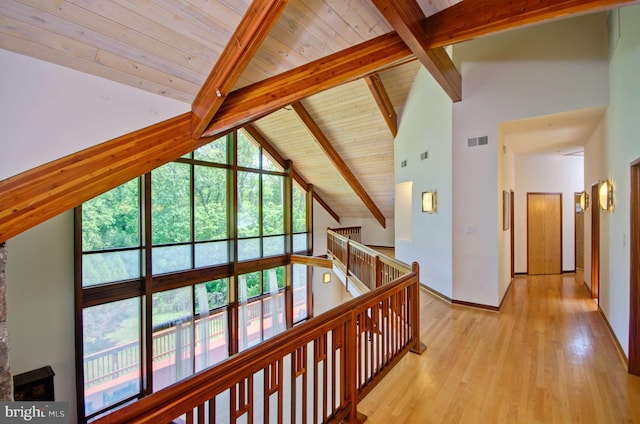 6525 76th St, Cabin John, MD 20818 - corridor featuring an upstairs landing, wooden ceiling with exposed beams, light wood-style flooring, high vaulted ceiling, and baseboards