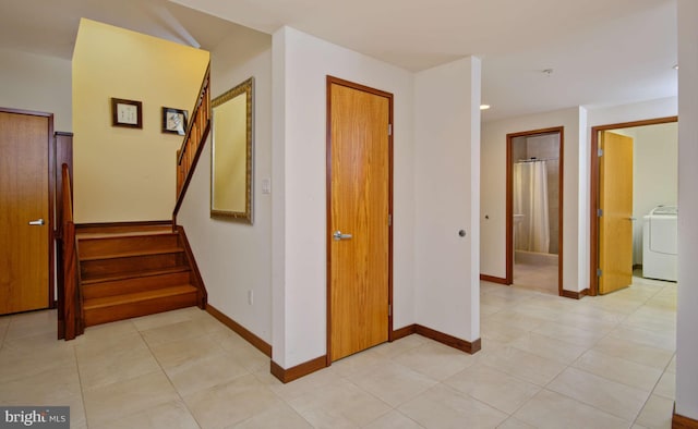 6525 76th St, Cabin John, MD 20818 - hall with washer / dryer, baseboards, stairs, and light tile patterned floors