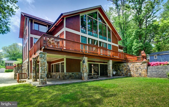 6525 76th St, Cabin John, MD 20818 - rear view of house featuring stone siding, a yard, and a wooden deck