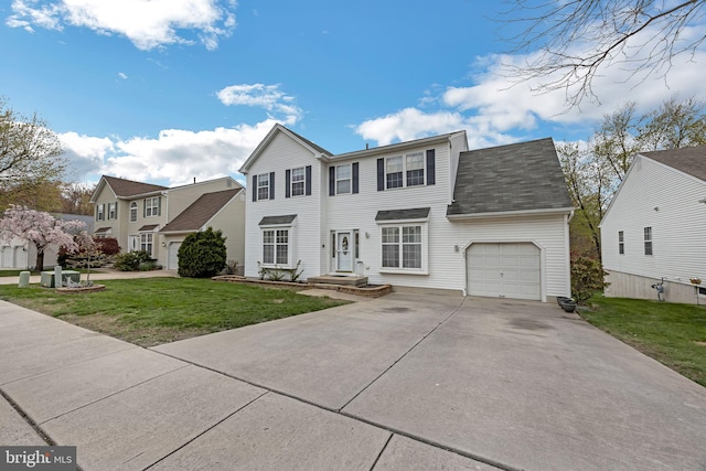 view of front of home with an attached garage, driveway, and a front yard