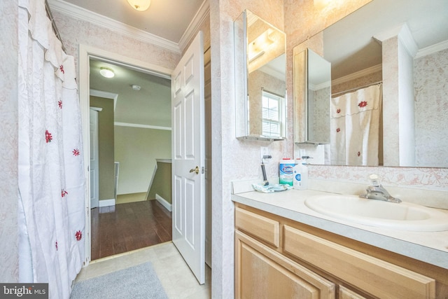 bathroom with crown molding and vanity