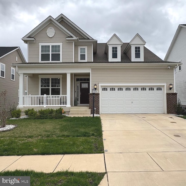 view of front of property featuring a front yard, a porch, an attached garage, brick siding, and driveway