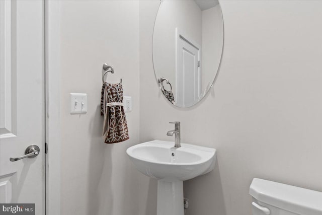 half bathroom featuring toilet
