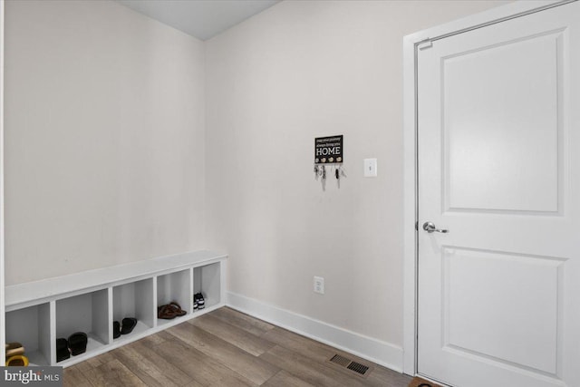 interior space with visible vents, baseboards, and wood finished floors