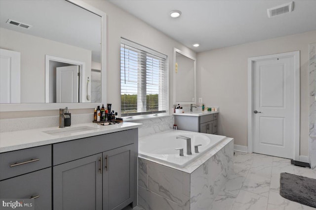 full bathroom featuring two vanities, visible vents, and a sink