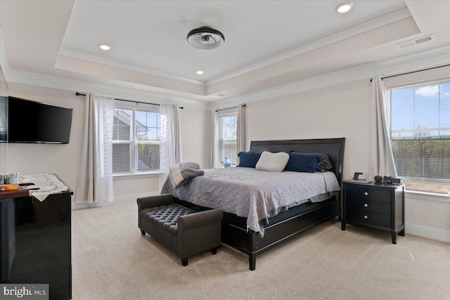 bedroom with a raised ceiling, light carpet, baseboards, and visible vents