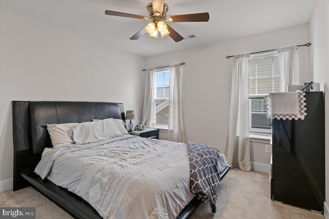 bedroom featuring carpet flooring, visible vents, baseboards, and a ceiling fan