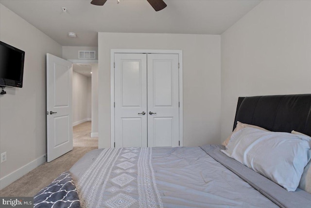 bedroom featuring visible vents, baseboards, a closet, ceiling fan, and carpet floors
