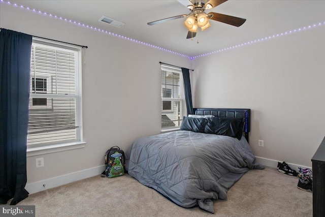 carpeted bedroom with visible vents and baseboards
