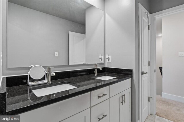 bathroom featuring double vanity and a sink