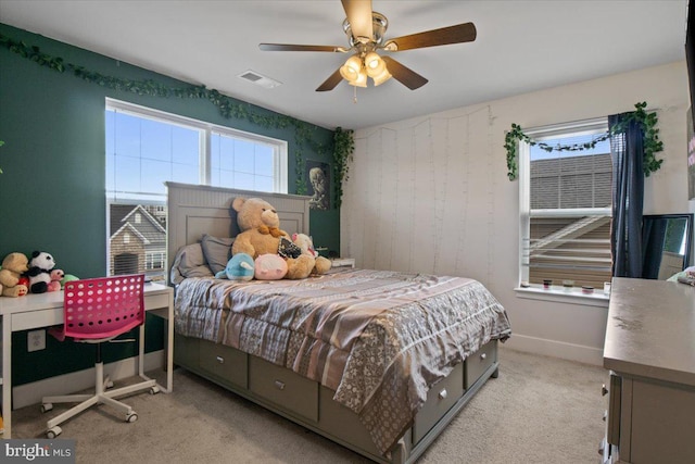 bedroom with light carpet, visible vents, baseboards, and a ceiling fan