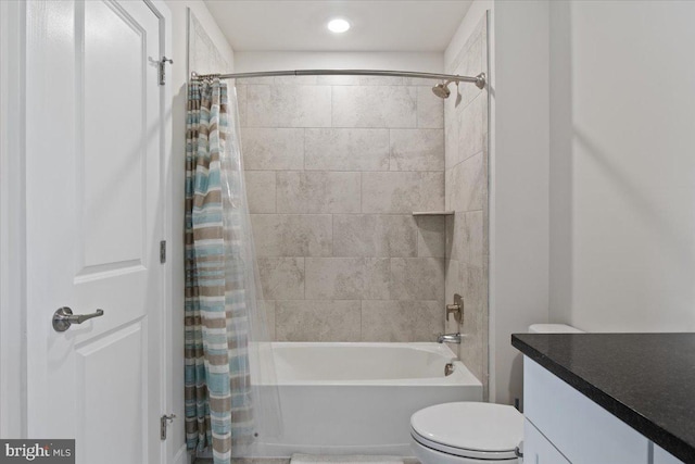 bathroom with shower / bath combo with shower curtain, vanity, and toilet