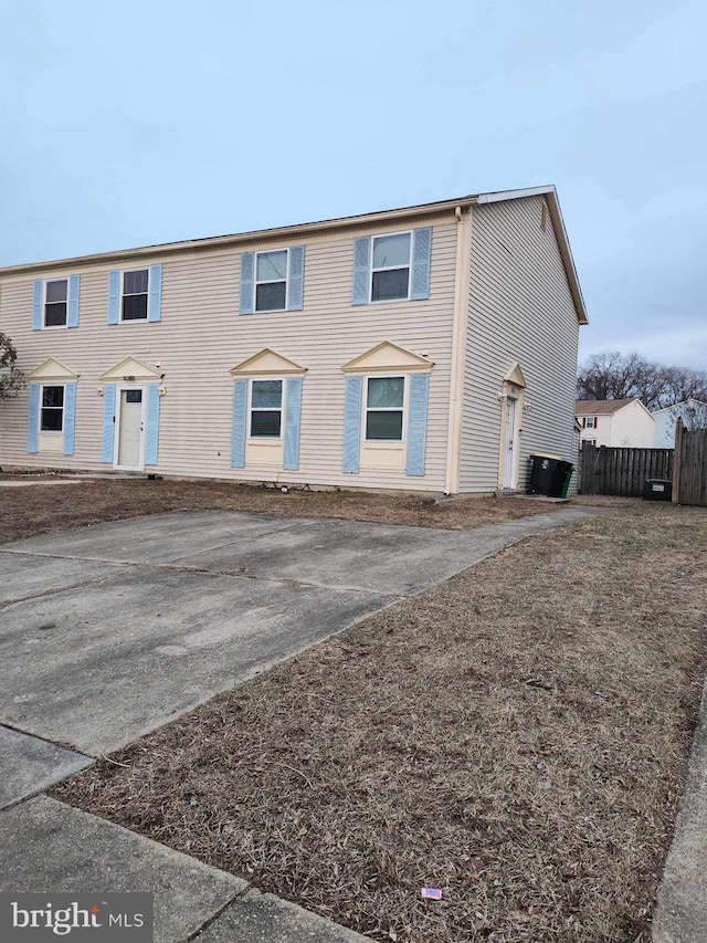view of front of property featuring fence and asphalt driveway