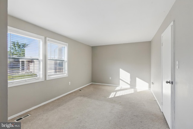 unfurnished room featuring carpet flooring and baseboards