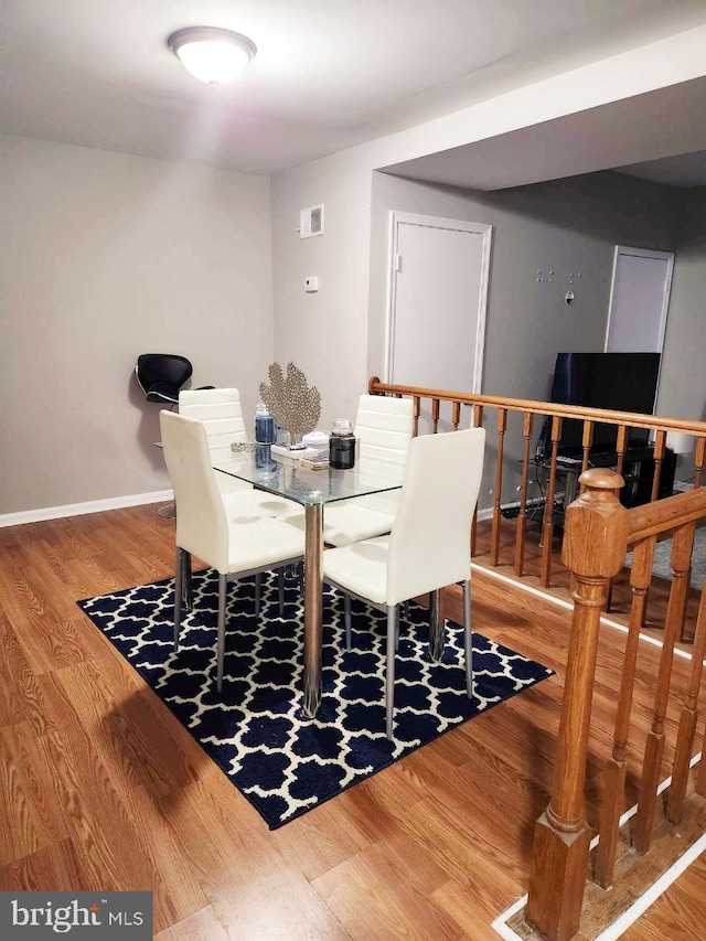 dining room with wood finished floors and baseboards
