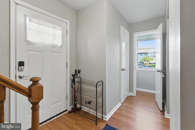entryway with light wood-type flooring and baseboards