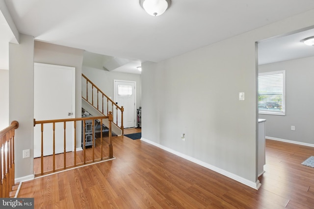 empty room featuring wood finished floors and baseboards