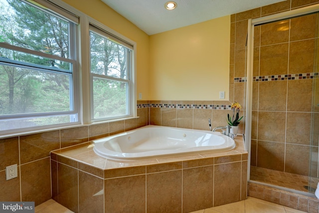 full bath featuring tile patterned floors, a garden tub, recessed lighting, and a tile shower