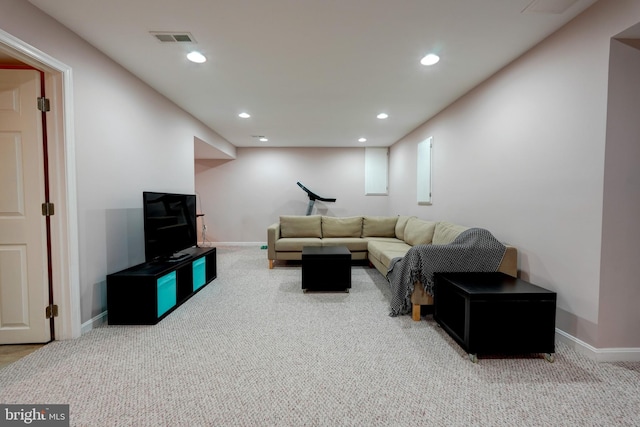 carpeted living area featuring recessed lighting, visible vents, and baseboards