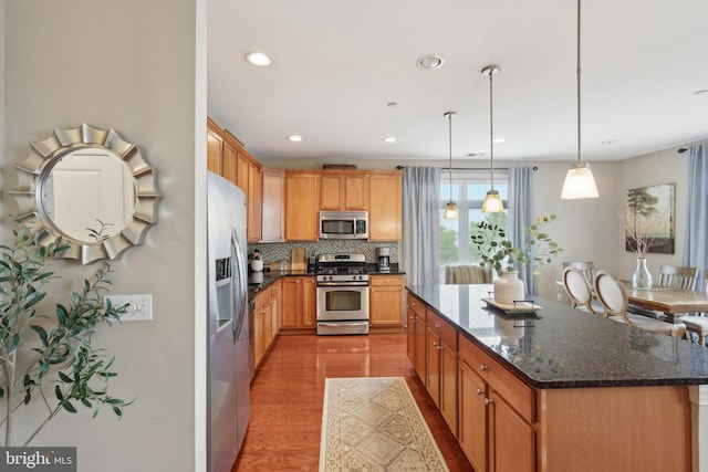 2 N Commerce Sq Unit 303, Trenton, NJ 08691 - kitchen with a center island, wood finished floors, stainless steel appliances, tasteful backsplash, and recessed lighting
