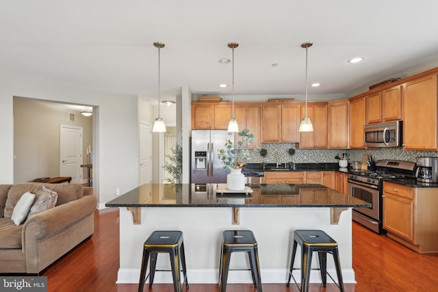 2 N Commerce Sq Unit 303, Trenton, NJ 08691 - kitchen with a breakfast bar, stainless steel appliances, backsplash, and dark wood finished floors