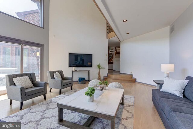 1 Fox Field Ct, Reisterstown, MD 21136 - living area featuring high vaulted ceiling, stairs, wood finished floors, and visible vents