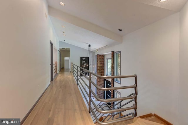1 Fox Field Ct, Reisterstown, MD 21136 - hallway featuring baseboards, lofted ceiling, light wood-style flooring, and an upstairs landing