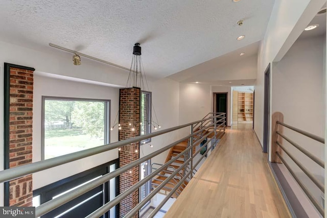 1 Fox Field Ct, Reisterstown, MD 21136 - hall featuring light wood-style floors, a textured ceiling, and an upstairs landing