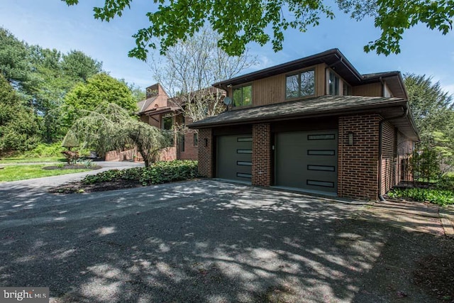 1 Fox Field Ct, Reisterstown, MD 21136 - view of side of property with a garage, brick siding, and aphalt driveway