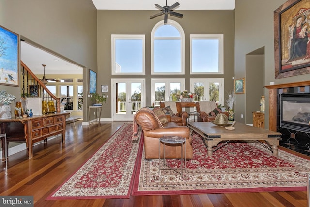 4083 Reels Mill Rd, Frederick, MD 21704 - living area with ceiling fan, a towering ceiling, a tiled fireplace, wood finished floors, and baseboards