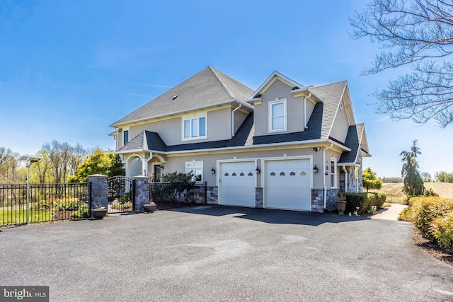 4083 Reels Mill Rd, Frederick, MD 21704 - view of front of property featuring driveway, fence, stucco siding, stone siding, and an attached garage