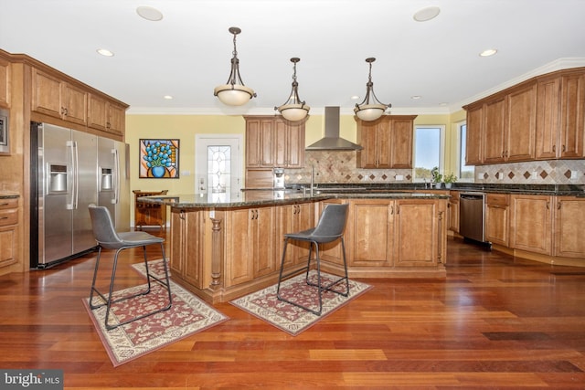 4083 Reels Mill Rd, Frederick, MD 21704 - kitchen featuring stainless steel appliances, wall chimney exhaust hood, dark wood-style flooring, a kitchen bar, and crown molding