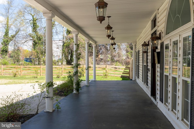 view of patio / terrace with fence and covered porch