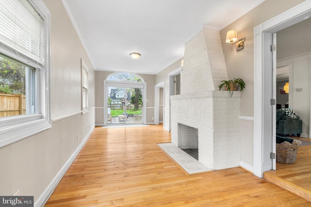interior space featuring hardwood / wood-style floors, baseboards, and ornamental molding