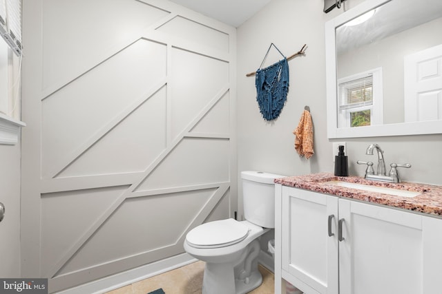 bathroom with tile patterned floors, vanity, and toilet