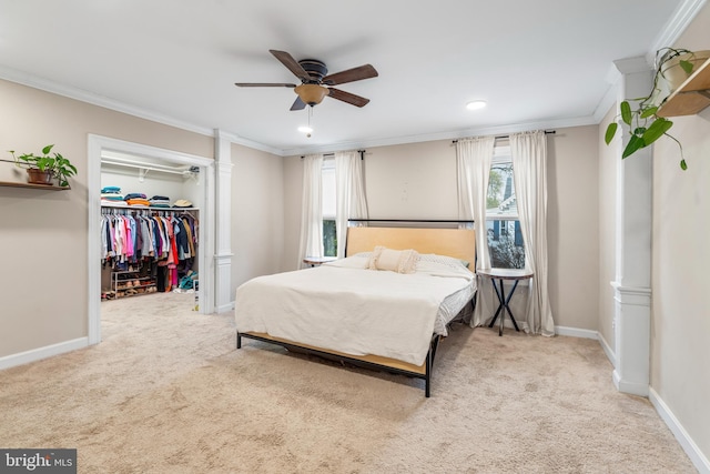 bedroom featuring a spacious closet, carpet flooring, baseboards, and ornamental molding
