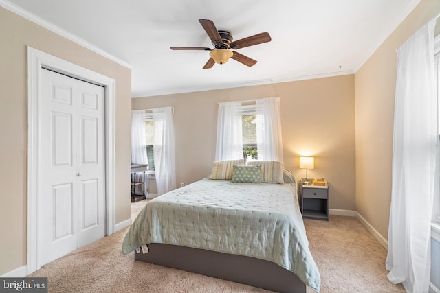 bedroom with a ceiling fan, light carpet, baseboards, and ornamental molding