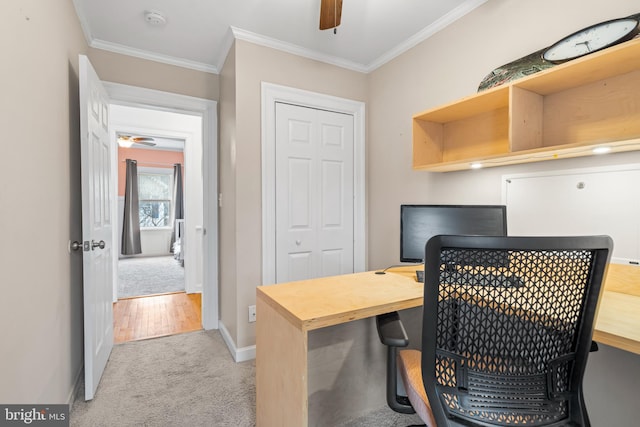 home office with light carpet, baseboards, crown molding, and ceiling fan