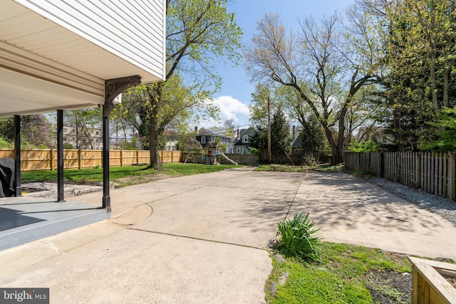 view of patio / terrace with a fenced backyard and a playground