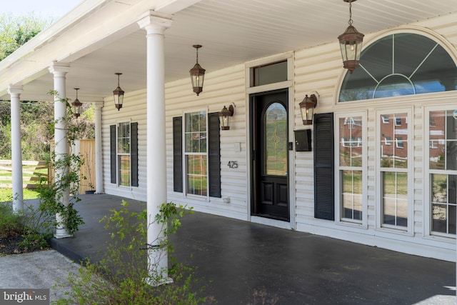 view of exterior entry featuring a porch