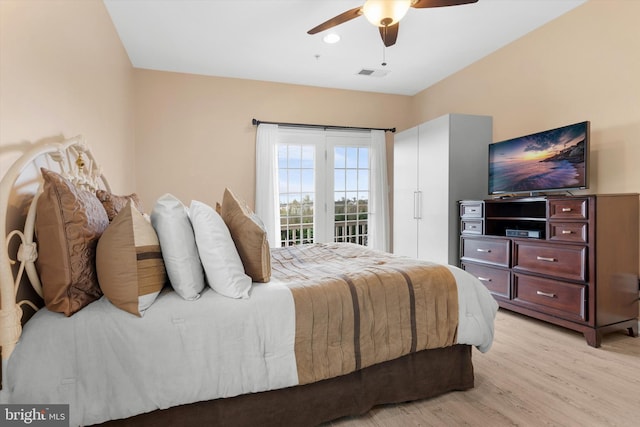 bedroom with ceiling fan, light wood-style floors, visible vents, and access to exterior